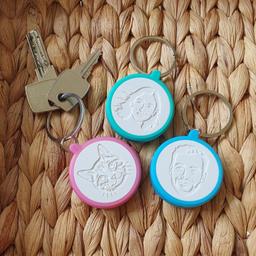 Three personalized keychains crafted from photos