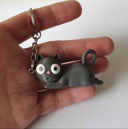 Tiny Chaos Cat keychain in hand for size reference, small cat keyring with big eyes